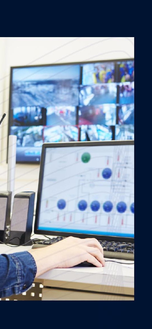 Operator monitoring a bank of BMS screens